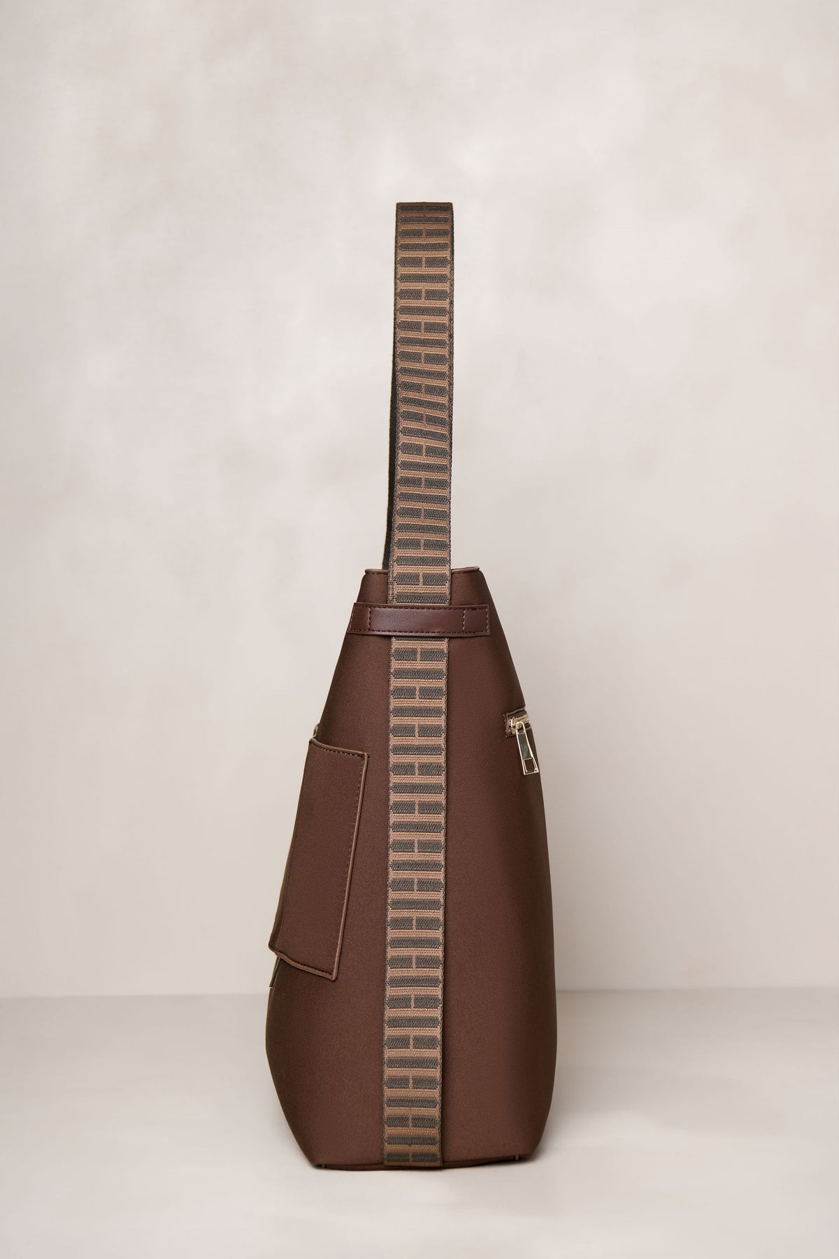 Chocolate brown convertible tote backpack bag in neoprene with gold hardware side view