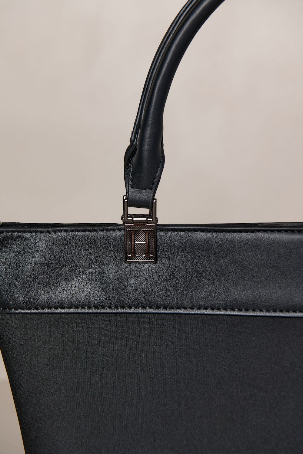 Black neoprene crossbody tote bag with handle and adjustable strap with gunmetal hardware