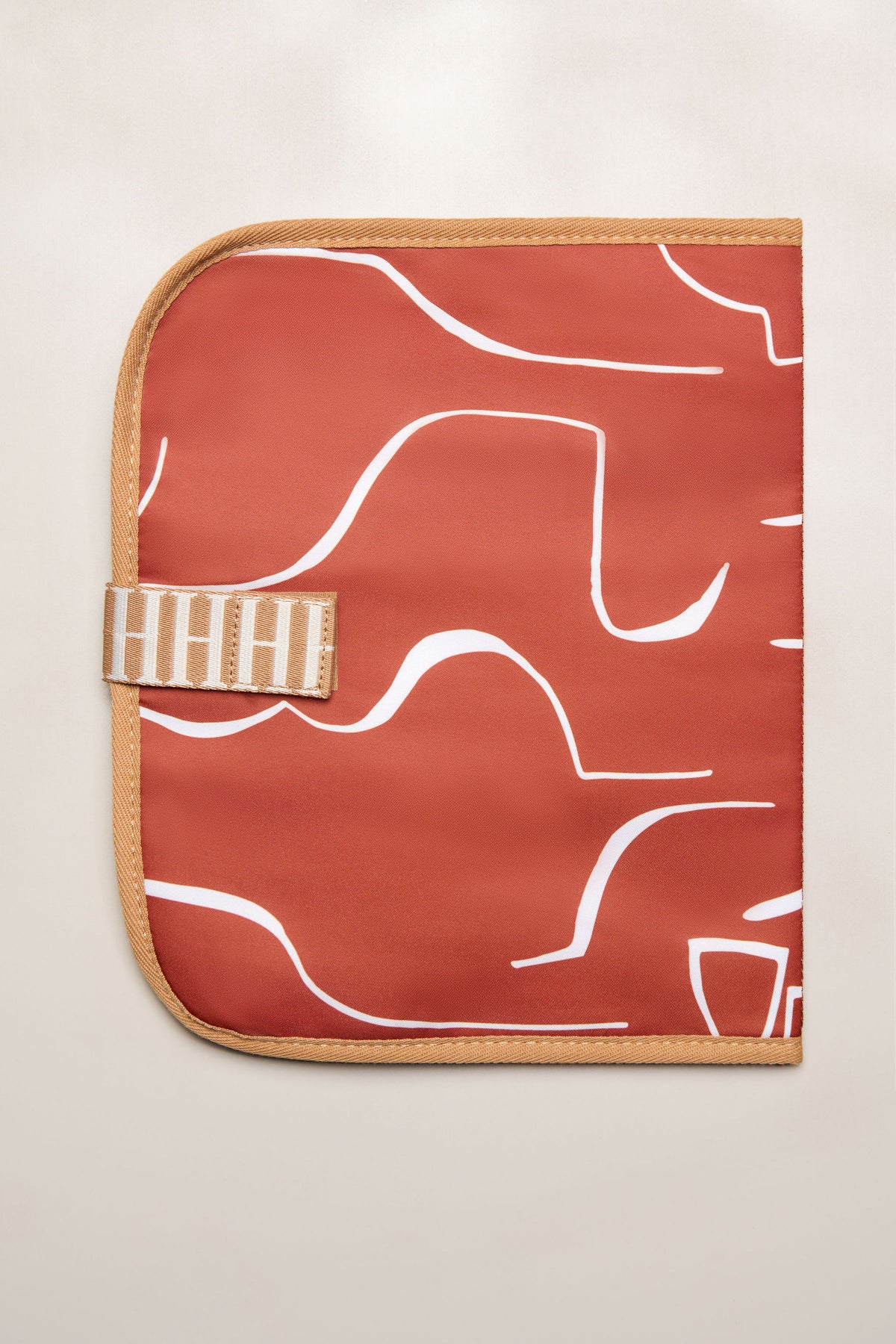 Tan Heiych change mat and laptop sleeve